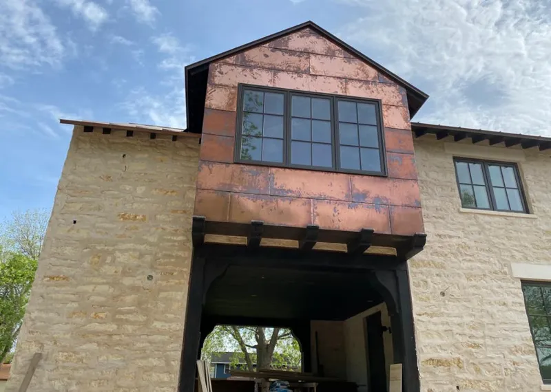 Copper metal panel facade on a stone building for Roof Repair in Desert Hot Springs